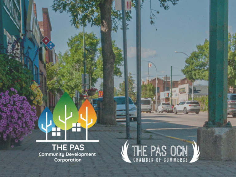 View of the sidewalk along Fischer Avenue with summer flowers, green trees, clean sidewalks and storefronts. Logo for The Pas CDC and Chamber.