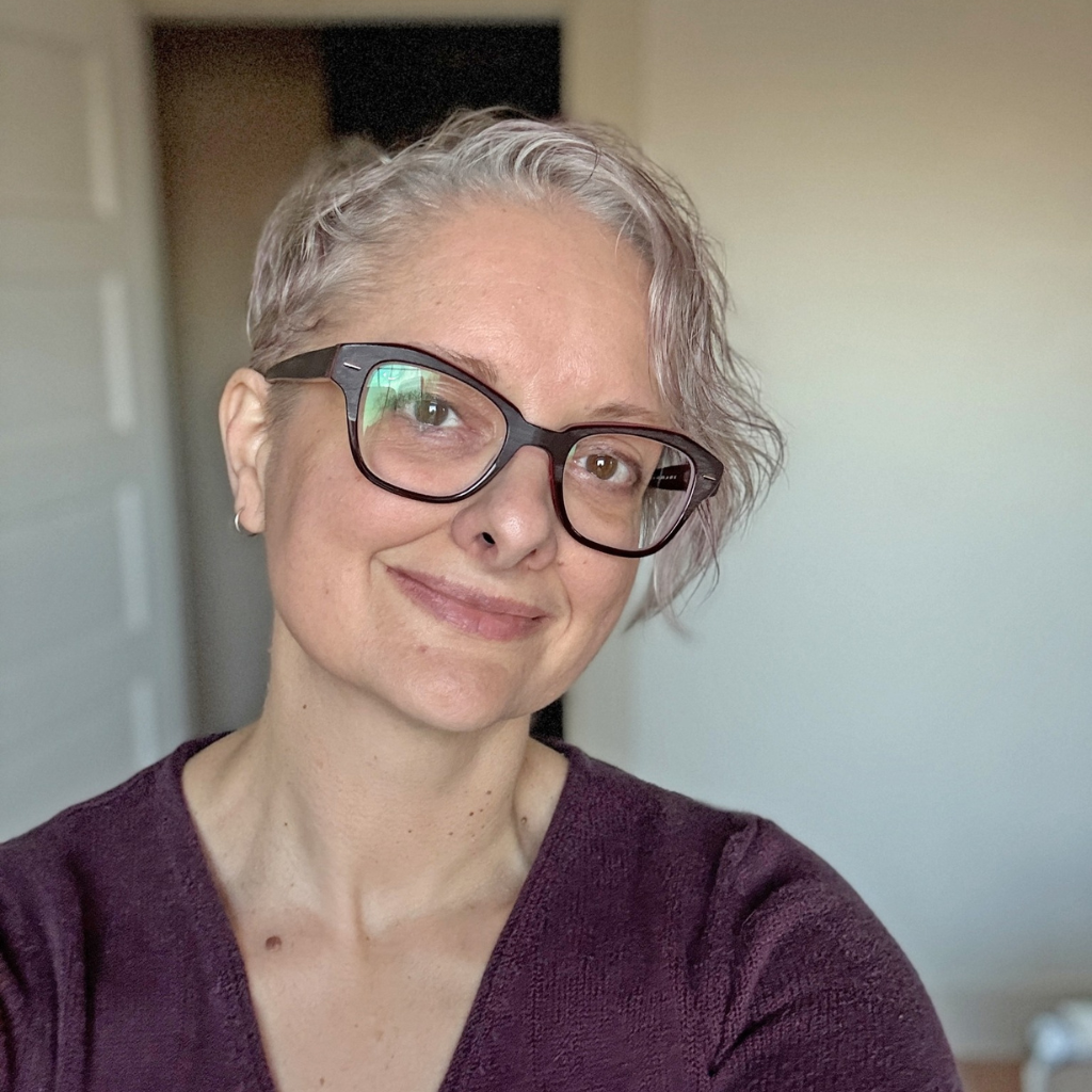 Donna Dawe, Chamber Secretary, wearing glasses, smiling at the camera